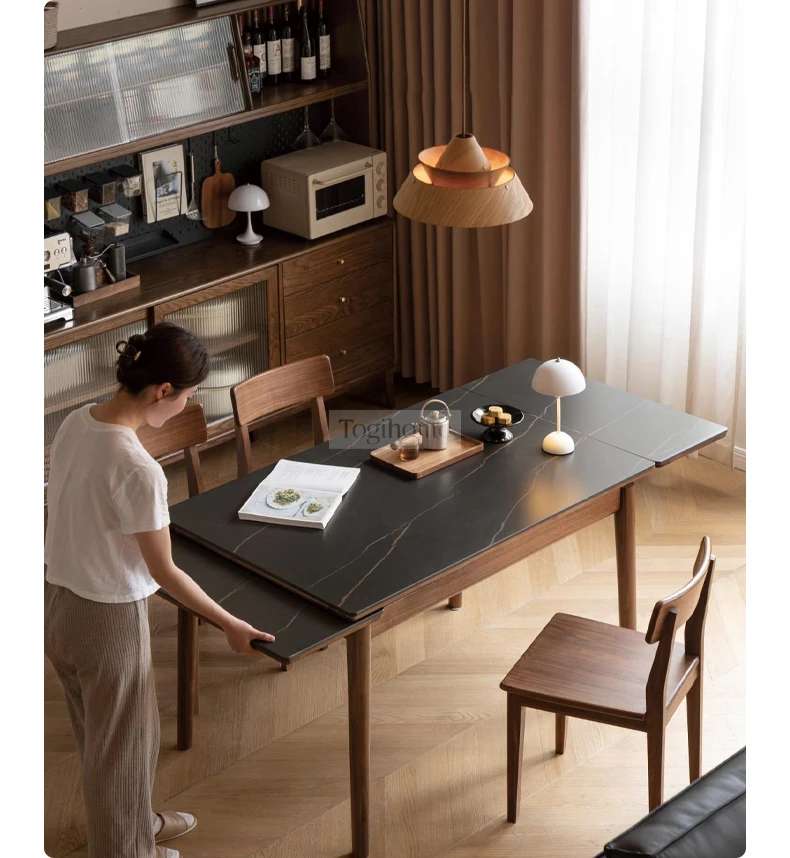 Bàn Ăn Gấp Gọn Thông Minh Gỗ Tự Nhiên Mặt Đá Togismart BA0212 thiết kế hiện đại, nhỏ gọn, dễ dàng mở rộng khi cần. Chất liệu gỗ tự nhiên bền chắc kết hợp mặt đá sang trọng, chống trầy xước, dễ vệ sinh. Giải pháp hoàn hảo giúp tối ưu diện tích và nâng tầm không gian sống.